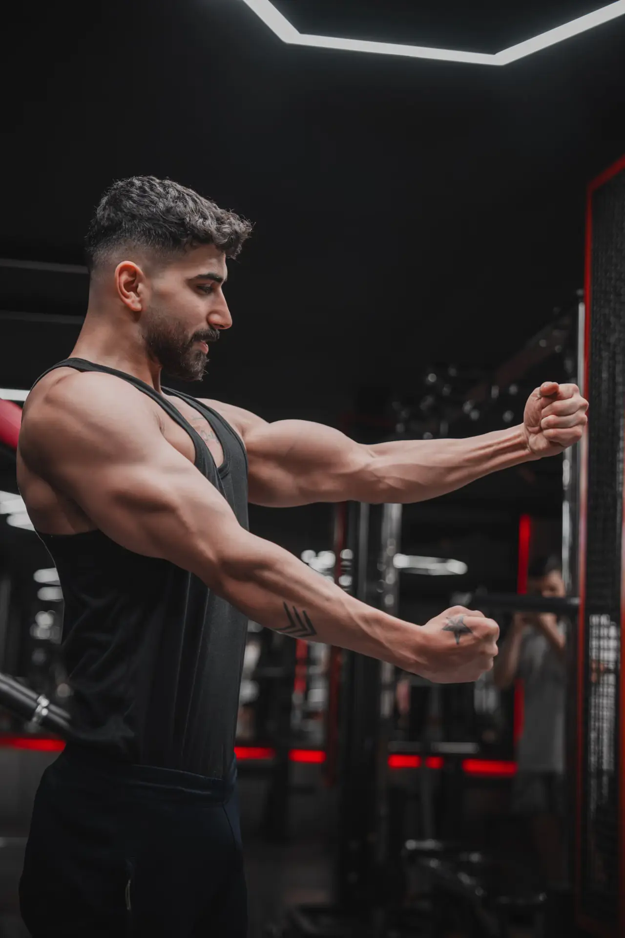 Man performing strength training in a gym.