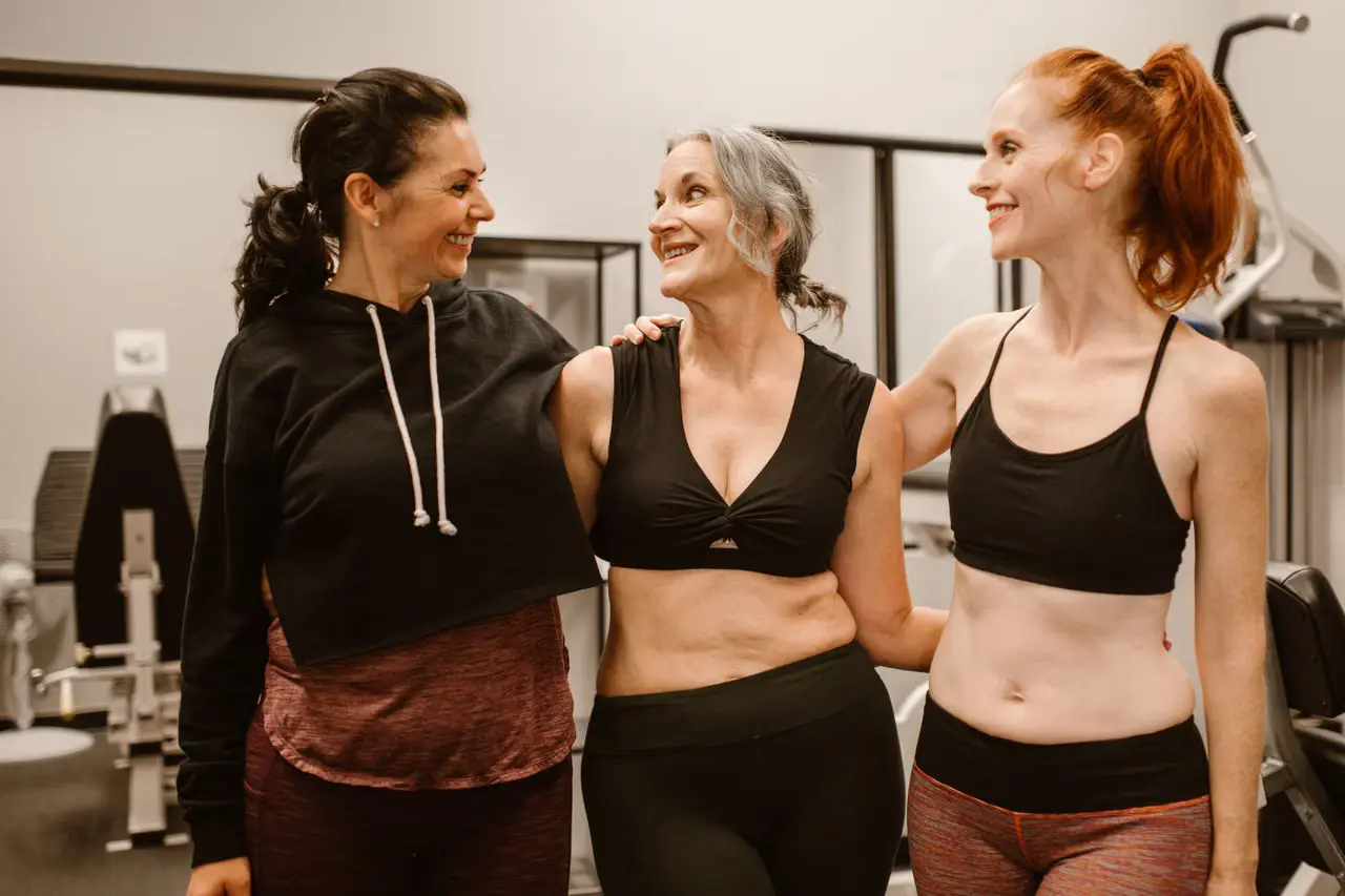 Midlife women exercising together in a gym, representing menopause health and wellness.