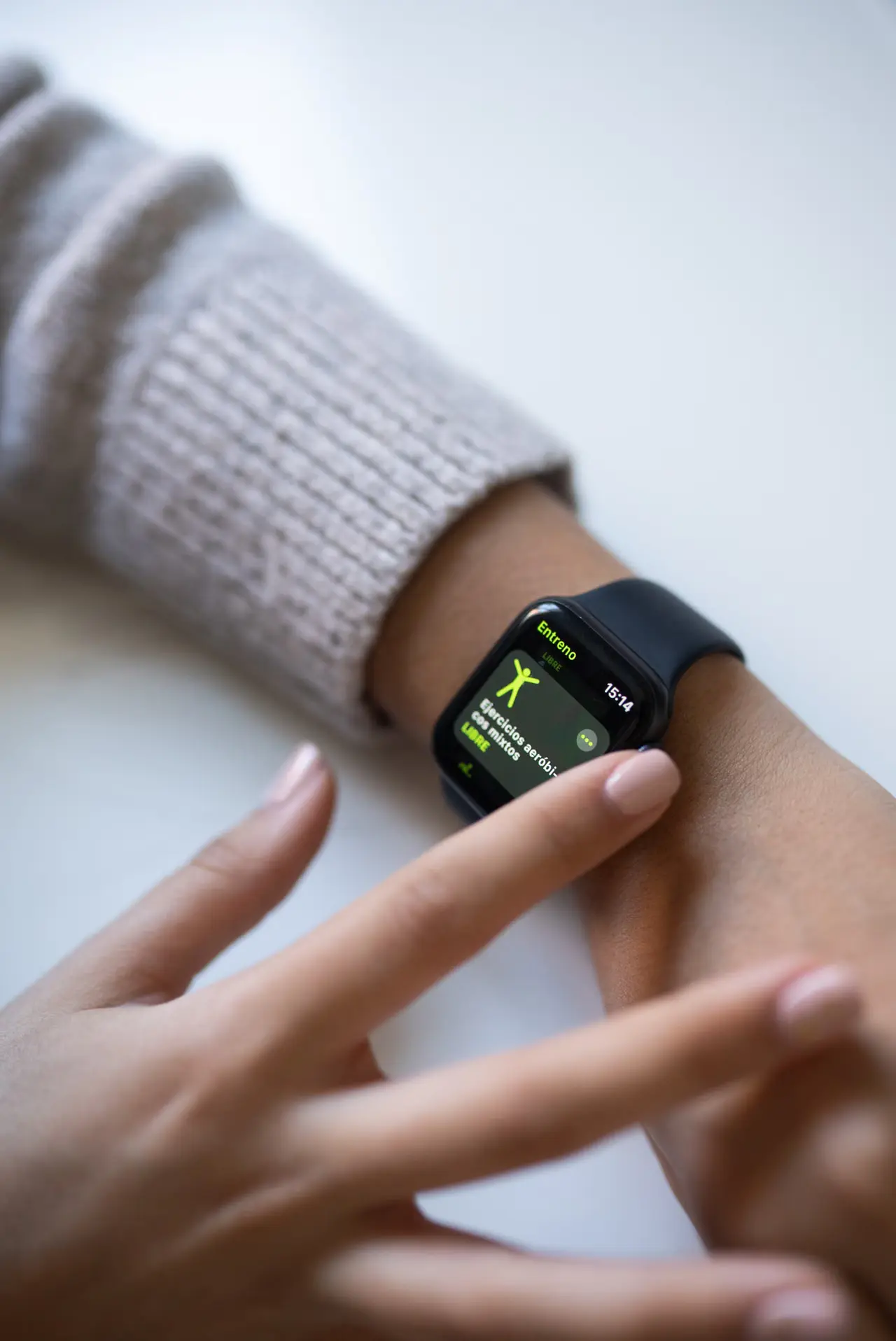 Person interacting with a black smartwatch during health tracking.